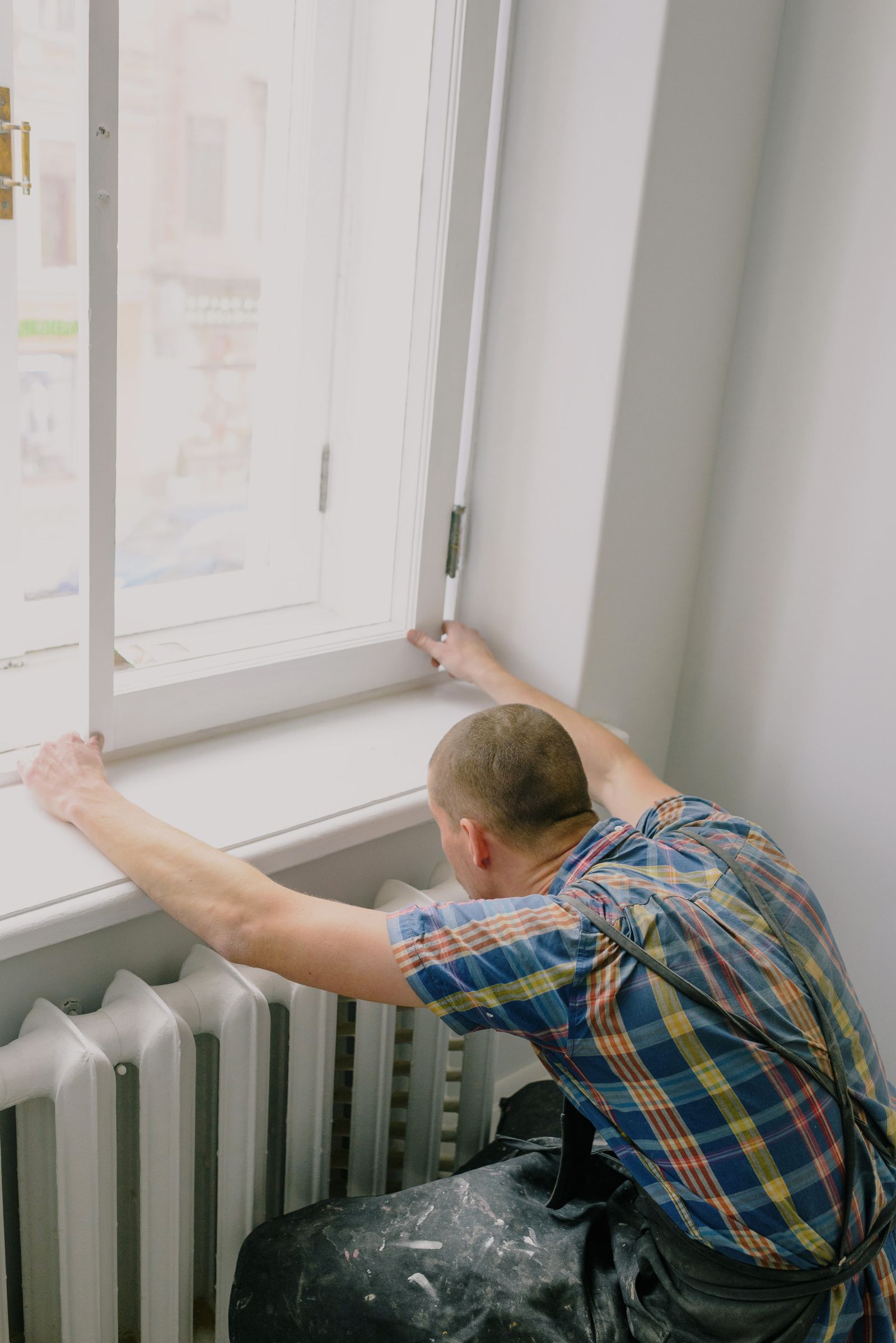 Insta Window Quote installer adjusting a newly fitted replacement window