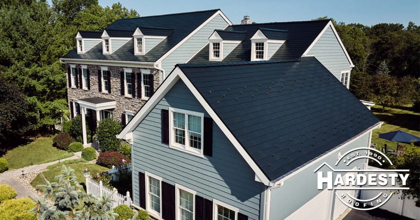 Dark standing-seam metal roof on a blue Central Virginia colonial home
